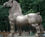 Muscular bronze stallion with weird human genitalia advertises provincial hotel